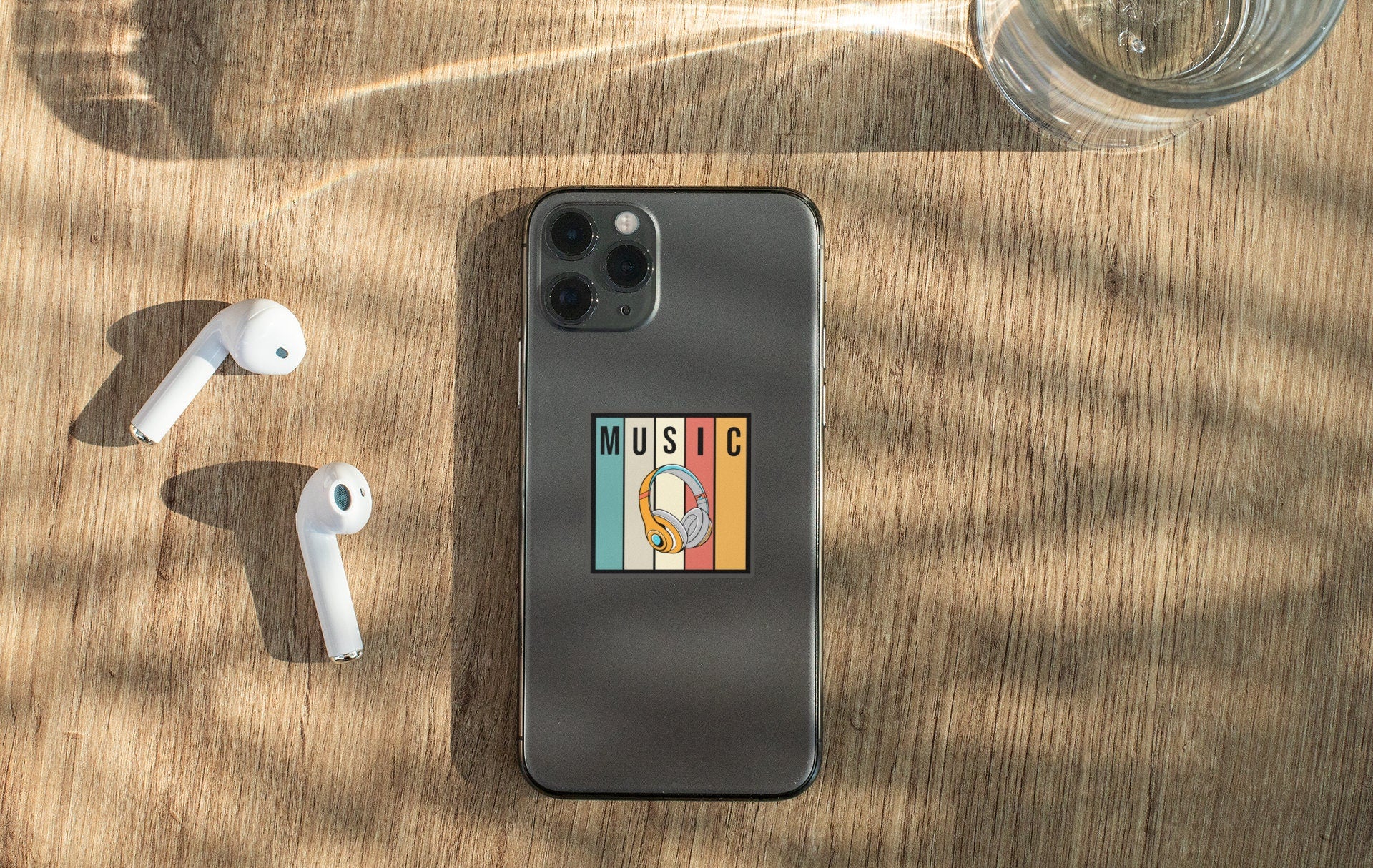 an iphone, ear buds, and headphones on a table